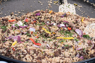 Seafood paella cooked in a large pan wok, street food festival. Mexican fiesta