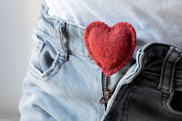 open zipper on men's jeans, soft red heart inside, the concept of romantic love, sexual harmony,...