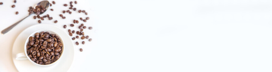 white cup and coffee beans on a white background. Selective focus.