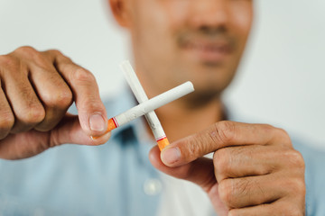 Man hand holding crossed cigarettes. Concept Quitting smoking,World No Tobacco Day.