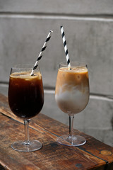 Milky iced coffee served in a beautiful glass with a paper straw