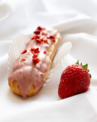 Strawberry eclair and strawberries on a white background