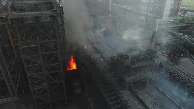 the coke pusher pushes the coke. Coke oven battery. coke and chemicals plant. drone flight over the plant