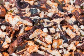 Octopus small chopped bites, street food festival. Seafood festival.