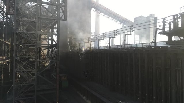 the coke pusher pushes the coke. Coke oven battery. coke and chemicals plant. drone flight over the plant