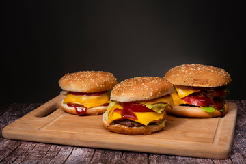 big fried cheeseburger on a dark background