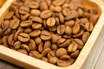 roasted coffee beans in wooden plate