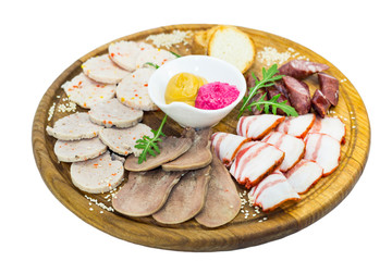 Wooden plate with several types of sausage and bacon sauce.
