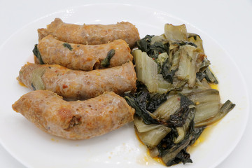 Spicy pork sausage served with Swiss chard - Italian cuisine