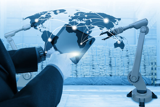 business man control robot arm in the warehouse for import export  with world map