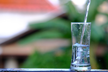 pouring water into glass