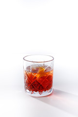 Red cocktail in a glass on a white background