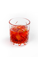 Red cocktail in a glass on a white background