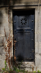 old door in the old crypt. Architecture details of antique cemetery monument in Paris France
