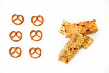 pieces of crackers and dried snacks bagels on a white background