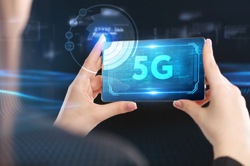 Obraz premium Business, Technology, Internet and network concept. Young businessman working on a virtual screen of the future and sees the inscription: 5G