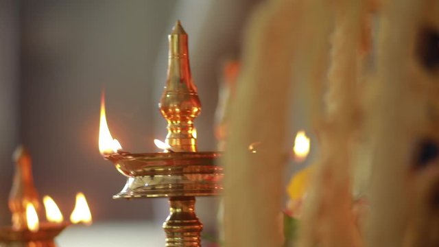 Traditional south Indian brass oil lamp 'Nilavilakku '. During events like housewarming, marriage etc., the Nilavilakku is lighted before starting the rituals. This video is taken during a wedding