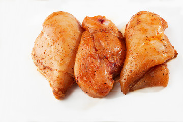 Marinated fillet isolated on a white background. Raw chicken breast fillets. top view with copy space. Flat lay composition with raw chicken breasts. Space for text. Meat shop.