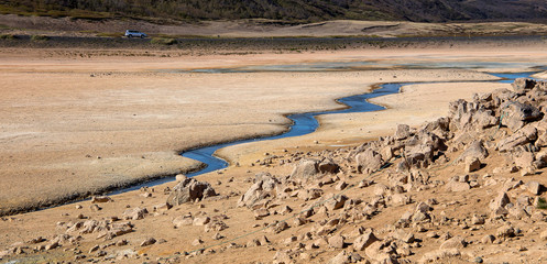 Tipical Icelandic nature landscape. Hverarondor Hverir geothermal area in  Iceland near Lake Myvatn.  The area with multicolored mud, cracked and steam. popular travel and hiking destination
