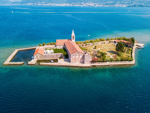 Aerial view of the island of Notre Dame de la Mis&eacute;ricorde, monastery in the Bay of Kotor near the island of Sveti Marko, Montenegro. Ostrvo Gospa od Milosrda. Fisherman fishing