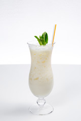 Glass of fresh healthy pineapple smoothie. White Background isolated