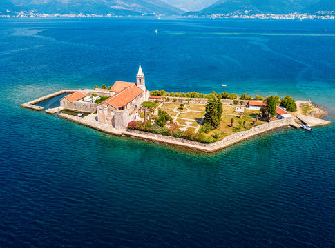 Aerial view of the island of Notre Dame de la Mis&eacute;ricorde, monastery in the Bay of Kotor near the island of Sveti Marko, Montenegro. Ostrvo Gospa od Milosrda. Fisherman fishing