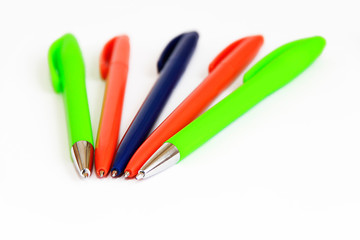 multi-colored stationery pens for writing on a white background