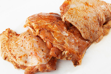 Free range Boneless chicken thighs on stone table. Raw chicken marinated thigh . The view from the Top. Food Background. Copy space. Cooking content. Meat shop.