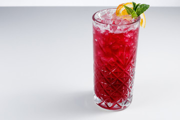 Red cocktail in a glass on a white background