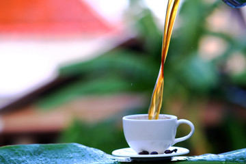 Coffee cup and coffee beans on wooden table background