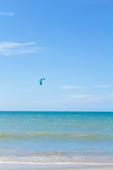 Tourist Beach, Cumbuco in Ceara, Northeast Brazil. Sunny day, weekend, beach holidays, hot summer. Man practicing kite surfing in the sea, doing sport. Sea and blue sky. Beautiful sunny day. Relaxing 