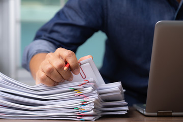 Man hand with pen Picking document For working from home, concept of social distancing coronavirus covid-19.