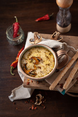 cream soup with mushrooms in a beautiful serving with bread sticks