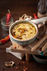 cream soup with mushrooms in a beautiful serving with bread sticks