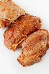 Free range Boneless chicken thighs on stone table. Raw chicken marinated thigh . The view from the...