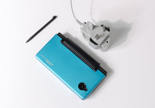 london, england, 05/05/2019 A metallic  blue nintendo ds dsi hand held vintage console on a white studio background. Retro video gaming handset. nostalgic computer and arcade game family fun