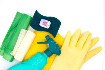 Cleaning products like a sponge, dishwasher tablet, gloves, spray bottle, garbage bag and a rag on white background with copyspace close up top view. concept clean house and hand care - Powered by Adobe