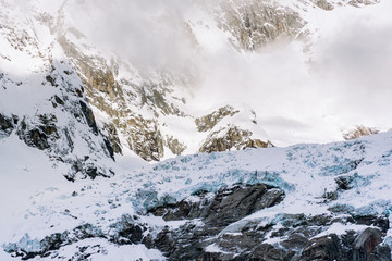 Snow covered rocks high in the mountains create a perfect alpine landscape and background