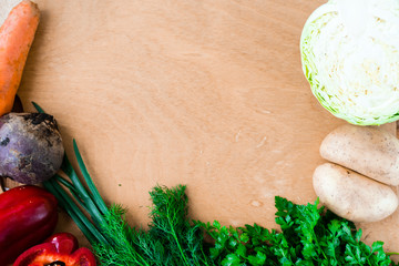 The layout of spring vegetables on a cutting board from above. Background layout with free text space.