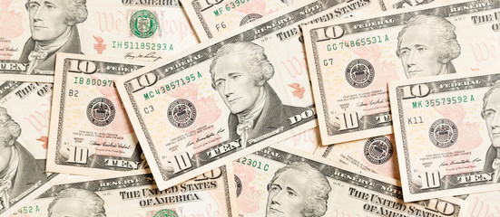 Top view of background made with 10 dollar banknotes. USD cash. American money concept