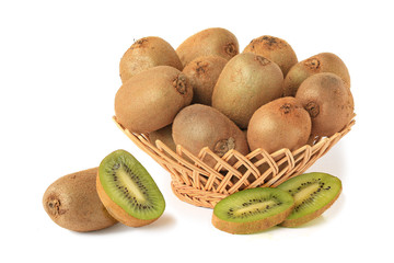 Delicious kiwi in wicker basket with half and slices isolated on white