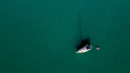 The drone captures a high angle view of monihull boat moored in the Andaman sea.