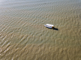 Fototapeta premium The drone captures a high angle view of inflatable boat moored in the Andaman sea.