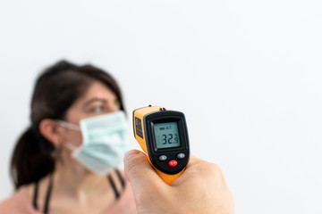 Fitness at home, equipment and tools for gym at home. Green dumbbell with towel, mobile phone on wooden parquet floor. Background with copyspace for sport activity at home with accessories.