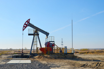 Fototapeta na wymiar Oil drilling derricks at desert oilfield for fossil fuels output and crude oil production from the ground. Oil drill rig and pump jack.