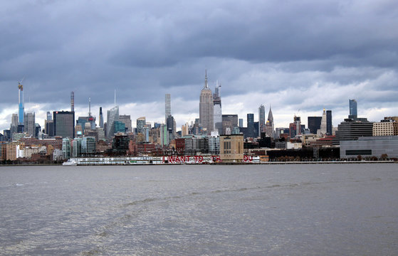 New york, USA - 20.12.2019: New York, Manhattan skyscrapers skyline behind across Hudson river at end of day New York, USA - stock photo