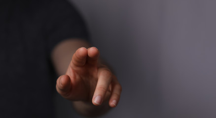 Obraz premium A man hand touching virtual screen, modern background concept , can put your text at the finger, copy space.