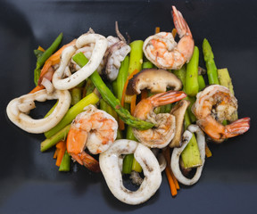 Stir fried asparagus with squid and shrimp with oyster sauce.