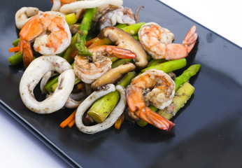 Stir fried asparagus with squid and shrimp with oyster sauce.