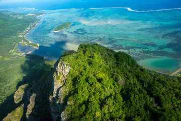 Aerial view to the top of the mountain of Le Morne Brabant and the blue lagoon. Mauritius. Picture taken from helicopter